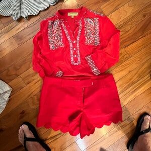 Red and pink top. Red shorts.